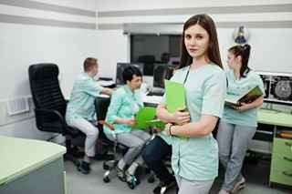Medical student studying with books and laptop