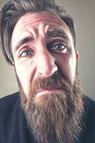 Close-up sad man with tear