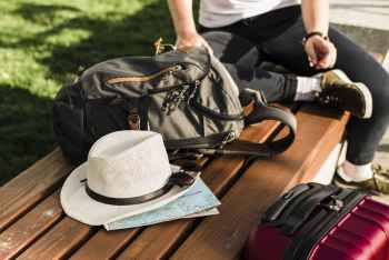 Travel essentials and packing items laid out for a tropical island vacation.